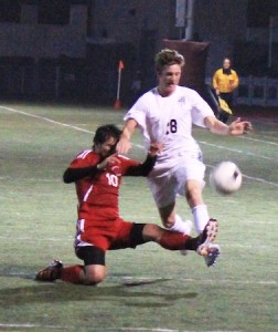 Sophomore Jake Hexberg gets tripped up by an Estancia player in Laguna’s 3-3 tie at home last Friday.