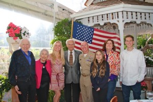 Photo by Matt Cole   Patriots Day Parade honorees, from left, Arnold and Bonnie Hano, Michelle Brown, Joseph A. Pursch, Grand Marshal Capt. Jason Ehret, an unidentified girl, Dee Challis Davy and Brock Csira