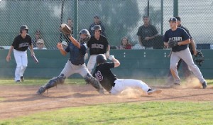 Senior Blake Hester slides in ahead of the throw to score in Laguna’s 6-3 league win over Calvary Chapel.