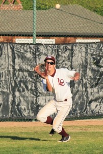  Senior left fielder Kaito Lee battles the late afternoon sun to haul in a fly ball in the Laguna’s 11-2 win over Jurupa in the opening game of the Newport Elks Tournament at Skipper Carrillo Field.