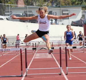 Freshman Coco Putnam clears the final hurdle in the frosh/soph 300m hurdles.