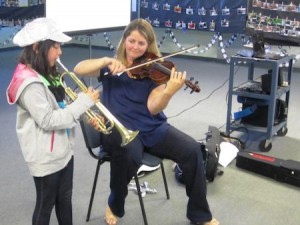Teacher Sara Warner and a student trumpet player.