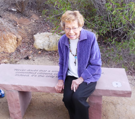 Conservancy President Carolyn Wood tries out a bench dedicated to the organization’s founder.Photo courtesy of the Laguna Canyon Conservancy 