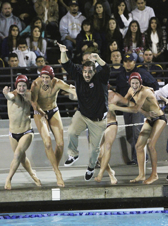 Head Coach Ethan Damato leaps into the pool to celebrate Laguna’s CIF championship. Damato won his third CIF title in six years as boys’ coach. He also has two titles as girls’ coach.