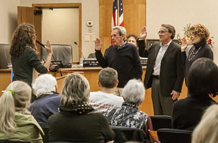 Newly elected City Council member Robert Zur Schmiede, center, flanked by incumbents Kelly Boyd and Toni Iseman, all take the oath of office.