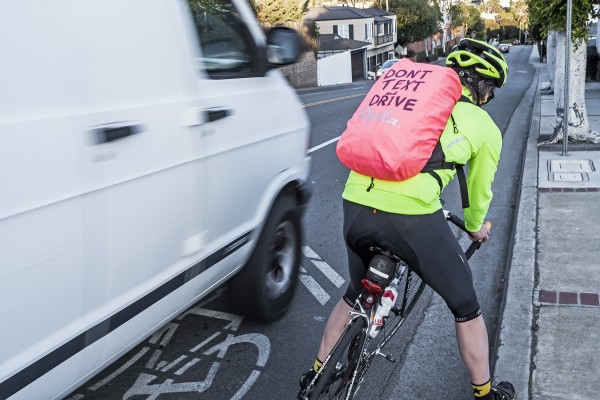 A van driver fails to give local cyclist Brett Howser the three-foot buffer now required by law despite his own efforts to alert drivers to his presence. Photo by Mitch Ridder.