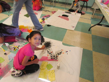 A preschooler assembles a self-portrait.