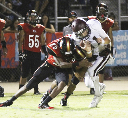 Sophomore Curtis Harrison gets pounded by the Segerstrom defense during the Breakers 45-0 road loss on Friday, Sept. 11. Credit: Dante Fornaro 