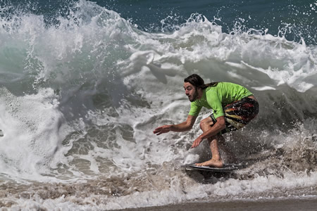Teddy Vlasis, 22 of Laguna Beach, streaks across a beach barrel.