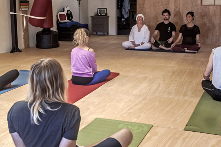 Instructors, from left, Cher Mang, Dava Shatz and Tiffanie Bederman lead donation-based yoga classes at Cho’s Academy. Photo by Mitch Ridder.