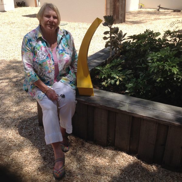 Kay Pastorius-Waller at the Sawdust Festival with the maquette of the missing sculpture, “Passport,” that she intends to donate to the museum.