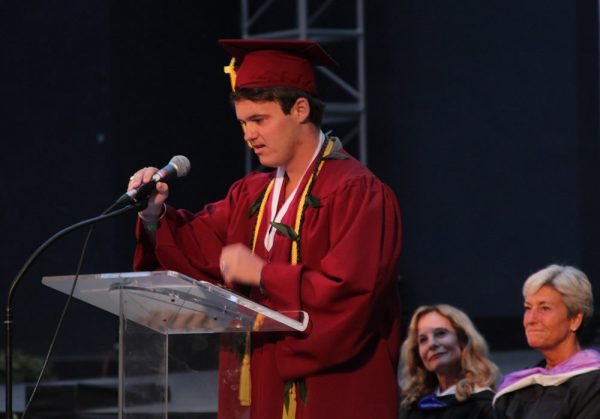 Mason Pitz delivers the senior address during the Laguna Beach High School 2016 graduation ceremony June 23. School board members Dee Perry and Ketta Brown are seated behind the speaker. 