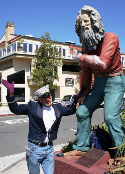 Michael Minutoli with a statue of Eiler Larsen, also a town greeter.