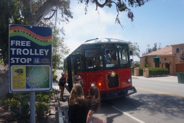 Residents board a new trolley that circles for the first time through Arch Beach Heights. 