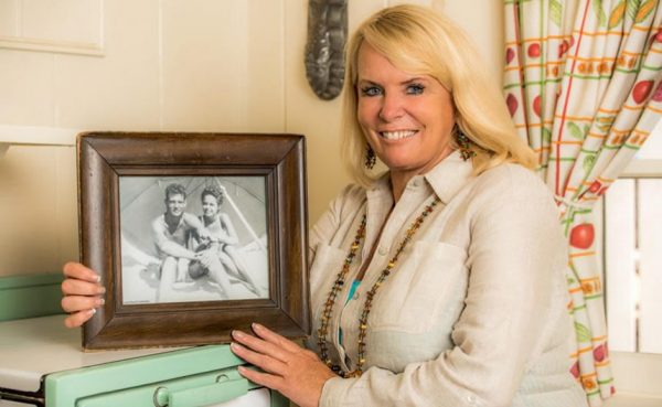 Laura Davick with a photo of her parents in Crystal Cove.           