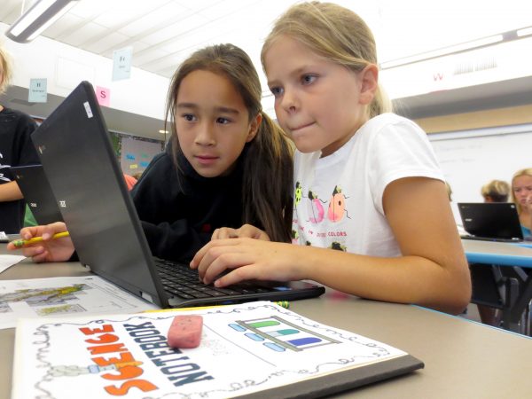 Fourth grade students Carley Anderson (right) and Presley Jones work in the STEM (Science, technology and math) lab at TOW on Nov. 9, 2016. They are looking on the internet for the best city in California to build a roller coster for their assignment. Photo by Marilynn Young