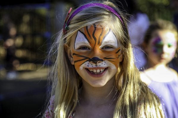 J.J. Forester shows off her tiger face, created by teacher Yuka Garrett at Anneliese Schools’ annual Oktoberfest.