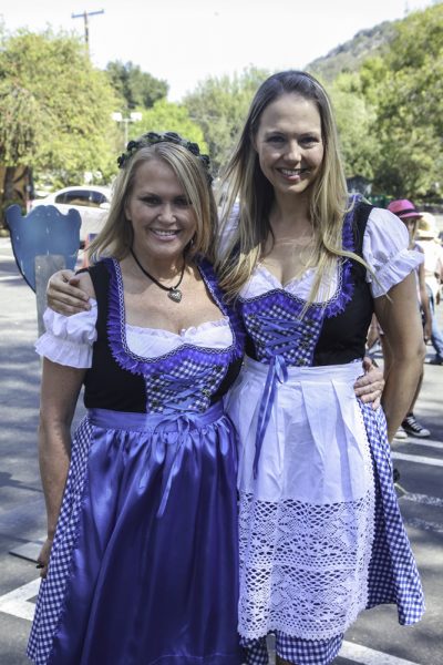 Terri Herkimer, a longtime school employee, and alumni Erin Sparkuhl don traditional Bavarian attire for Oktoberfest.