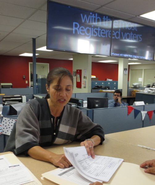 Campaign disclosure filing officer Christina Avila helps a patron at the Registrar of Voters office in Santa Ana on Tues. Nov. 1, 2016 Photo by marilyn Young.