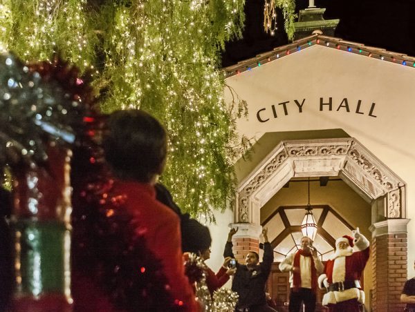 Santa and former Mayor Bob Whalen in 2014 throw the switch at City Hall tree on Hospitality Night. This year, merchants are required to seek permits before serving libations. Photo by Mitch Ridder