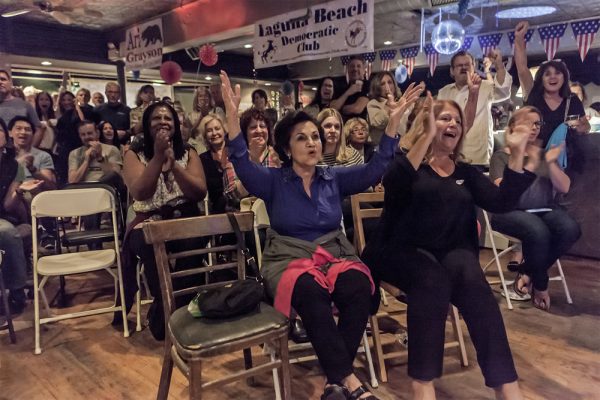 Early results on election night in November elicit a cheer, where a majority of Orange County voters endorsed a Democrat for the first time in 80 years. Photo by Mitch Ridder.