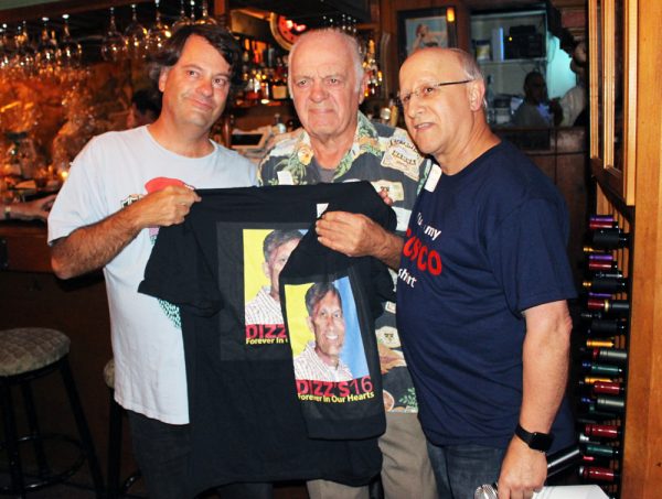 Marc Pitz’ father and brother receive memorial t-shirts at a hospital fundraiser.  