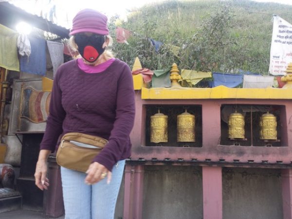 To combat Kathmandu’s pollution, Russell wears a face mask as she travels about the capitol.  