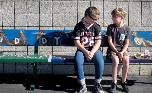 Johnni Muir, left, and friend Wyatt, meet this week at the buddy bench, a simple idea to eliminate loneliness and foster friendship on the El Morro Elementary playground.Photos by marilynn Young.