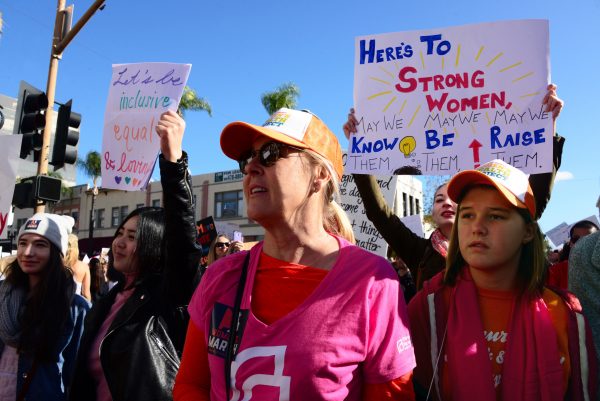Laguna Beach resident Kelly Cecutti, center, marches with her 13-year-old daughter Giovanna Cecutti in Santa Ana along with an estimated 20,000 other people in the OC Women's March Saturday, Jan. 21. Photo by Adrienne Helitzer.