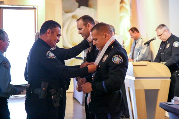 Lt. Joe Torres awards Detective Jordan Mirakian a life saving medal for assisting a man who collapsed while choking. 