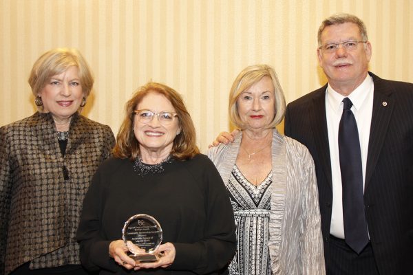 League representatives, from left, Gayle Whitaker, Catherine Hall and Judy Sterns accept an award from Regional Center top executive Larry Landauer. 