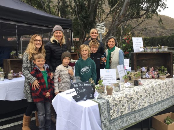 CLC parents and students sell homemade wares to benefit a homeless organization at the farmers market in Laguna Beach last December. From left, parents Deborah Johansson, Nicole McMann, Laura Sauers and Gerri Machin with  Magnus Johansson, Hendricks McMann, Callum Murray and Max Sauers. 