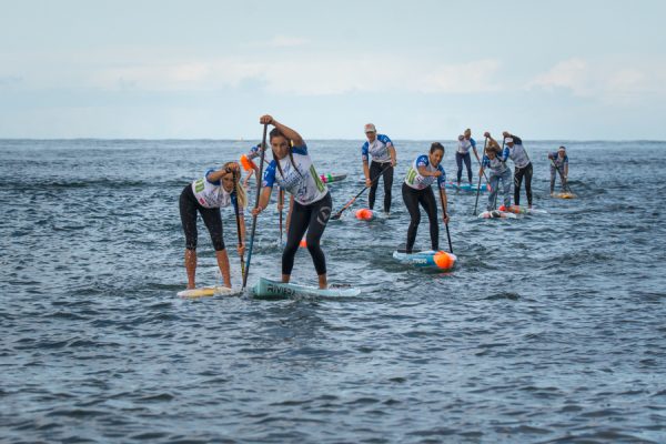 Jade Howson, of Laguna Beach, center, competes in a stand-up paddle board competition in Denmark. Photo courtesy International World surfing Assoc.