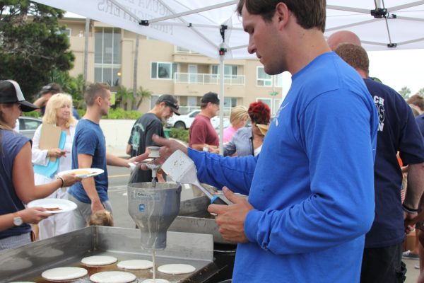 Lifeguard Steve Mais perfects his pancake pours at Monday’s Exchange Club breakfast in Heisler Park