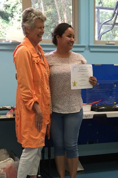 Teacher Peg Donner, left, presents an achievement award to a La Playa student enrolled in classes during the last school year.