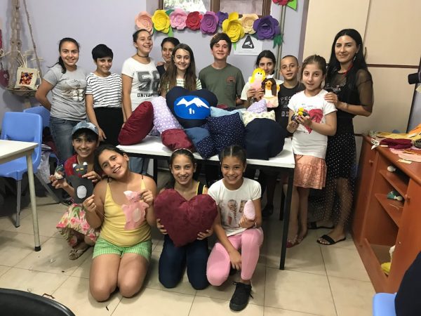 Heritage provides the inspiration for local scouts, Ani and Joseph Hovanesian, center, back row, to start a sewing program for youth in Armenia. photos by Tanya Hovanesian.