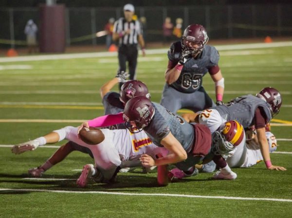 Shane Lythgoe bangs out a run into Estancia’s secondary on Laguna’s first touchdown drive behind blocking by Curtis Harrison and Adam Armstrong. 