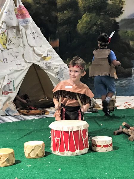 Five-year old Charles Harris beat drums and smiled through the war paint on his cheeks. 