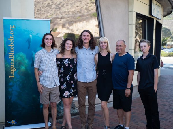 Amateur category prize-winner, Noah Munivez, center, celebrates his win with family and friends at the Bluebelt reception, which took place June 9.