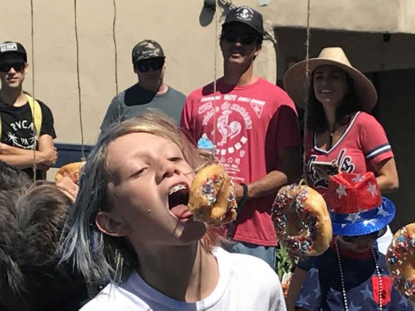 Jack Bryan tries for a bite of a donut on a string prior to the informal South Laguna July 4 parade. Photos of South Laguna celebration by andrea Adelson.