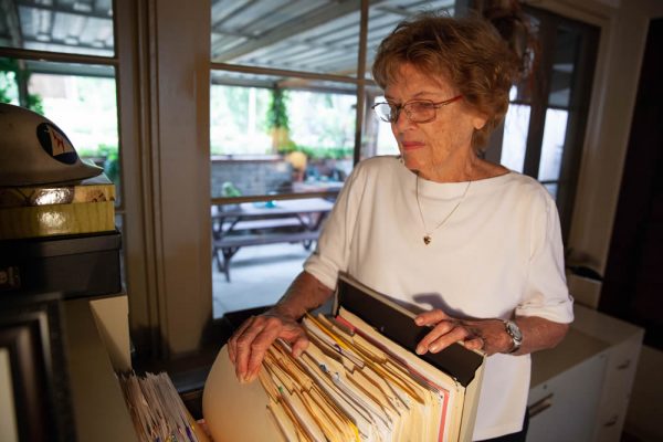 Jane Janz goes through one of her many filing cabinets full of research materials and old articles in her Laguna Beach home. Photo by Allison Jarrell