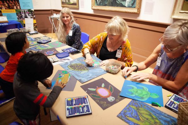 Sawdust Art Festival faculty lead young visitors in creating festive turtle drawings during the Laguna Art Museum’s 100th birthday party.
