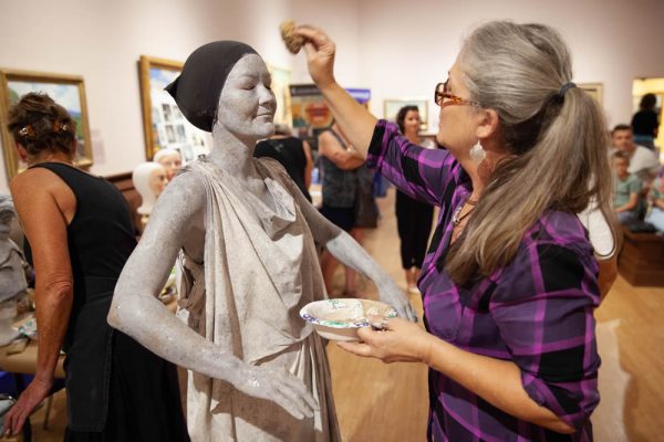 Pageant of the Masters model Michelle Pohl, 37, of Yorba Linda, holds statue-still as Kim Knowlton puts on the finishing touches at the museum’s 100th birthday celebration.