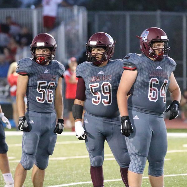 In the trenches, #56 Calob Molstajo, #59 Matt Gallegos and #64 Hunter Davis in action versus Big Bear. Photo by Lisa Fields 